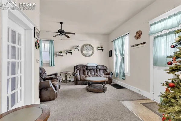 a living room with furniture gym equipment and a chandelier