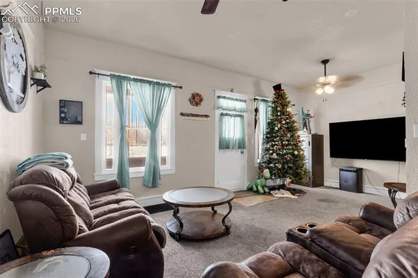 a living room with furniture and a flat screen tv