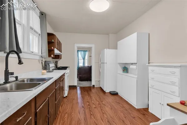 a kitchen with a sink stove and refrigerator