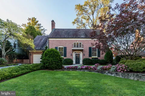 a front view of house with a garden