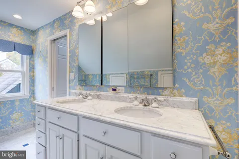 a bathroom with a sink double vanity and a mirror