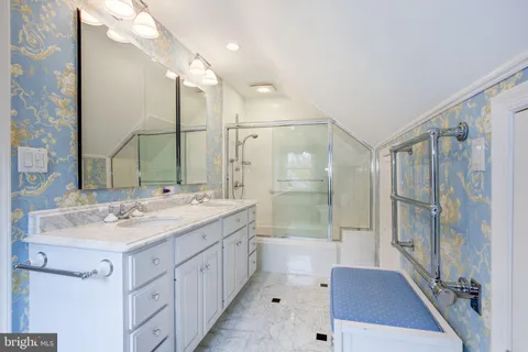 a spacious bathroom with a shower sink and mirror