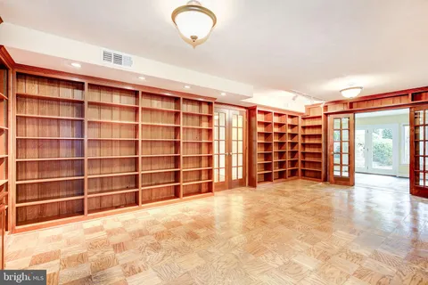 a view of an empty room with a window and storage