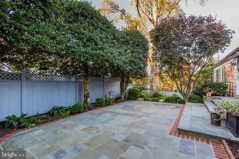 a view of a chair and table in the backyard of the house