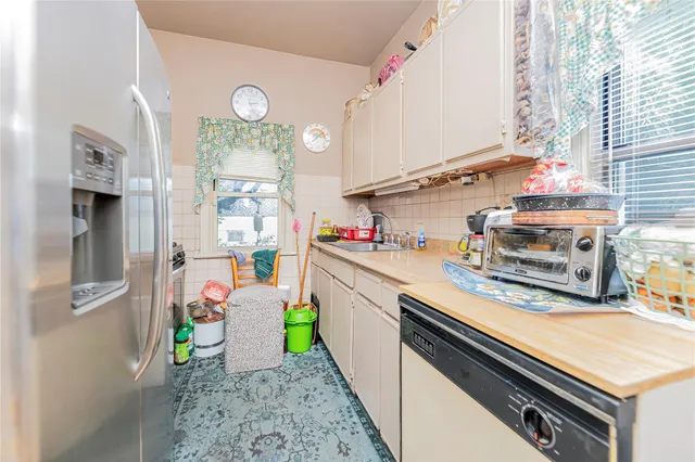 a kitchen with a refrigerator and a stove