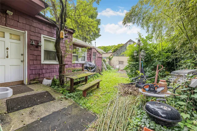 a backyard of a house with outdoor seating