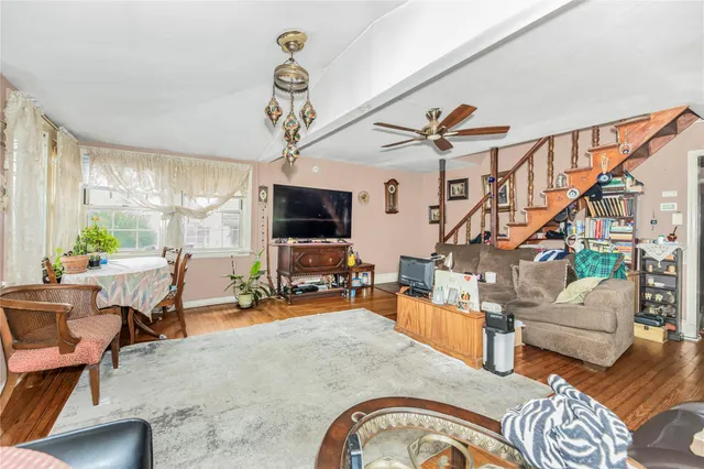 a living room with furniture a flat screen tv and a chandelier