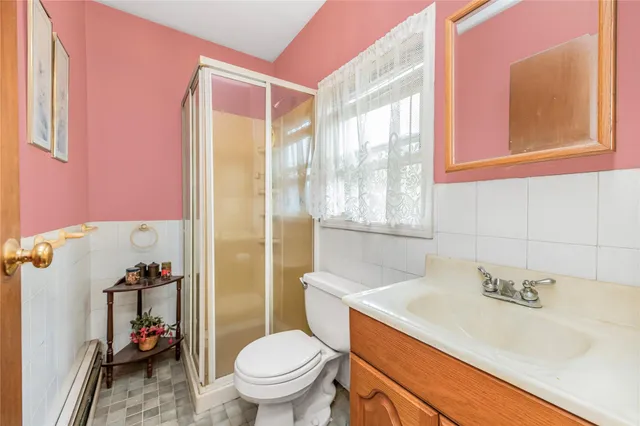 a bathroom with a sink toilet vanity and tub