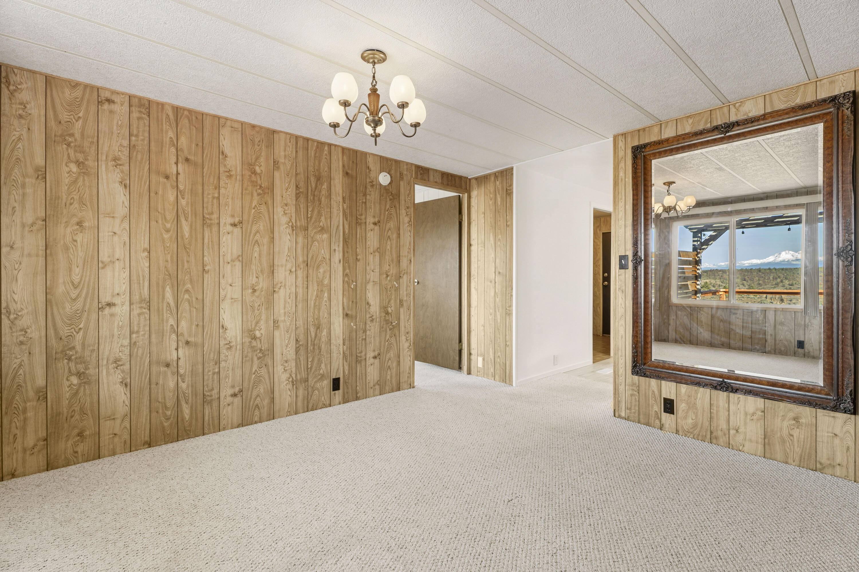9318 Southwest Panorama Road Terrebonne, OR 97760 - Photo 15 of 45 a view of a big room with a chandelier fan and windows