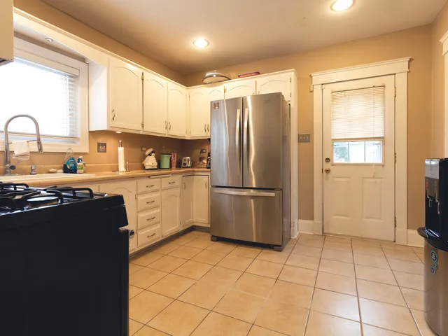 a kitchen with stainless steel appliances a refrigerator sink and cabinets