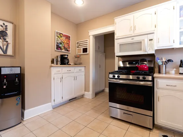 a kitchen with stainless steel appliances granite countertop a stove and a refrigerator
