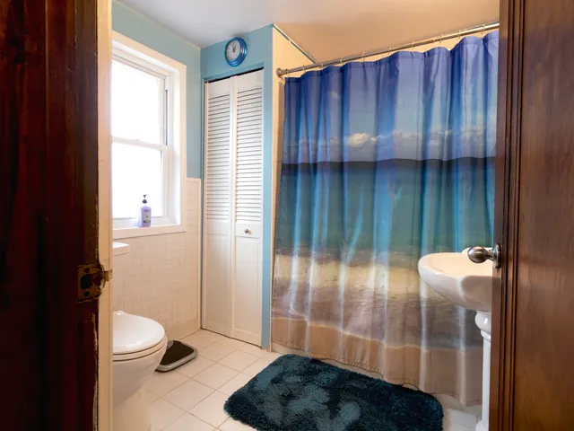 a bathroom with a toilet and a shower