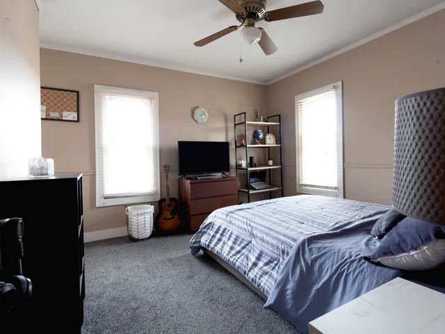 a bedroom with a bed and a flat screen tv