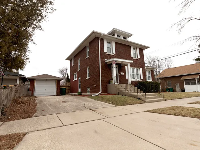 a front view of a house with a basket ball court