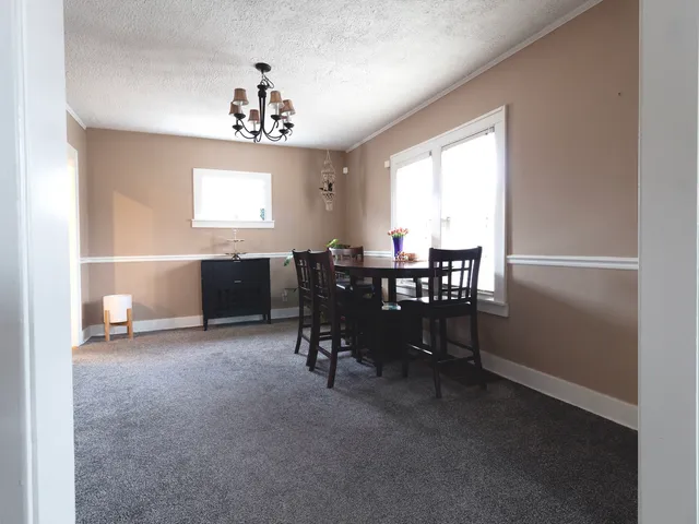 a view of a dining room with furniture window and outside view