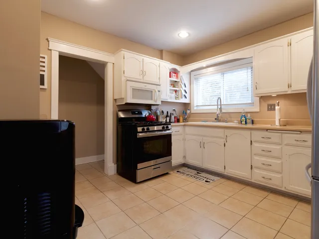 a kitchen with a white cabinets and white appliances