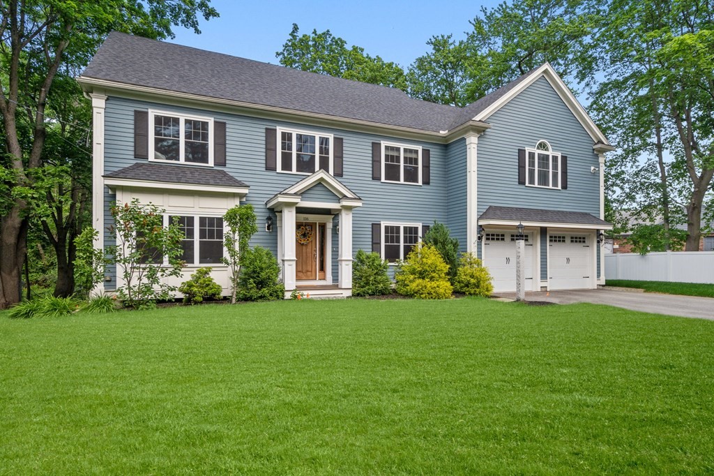 a front view of a house with a garden