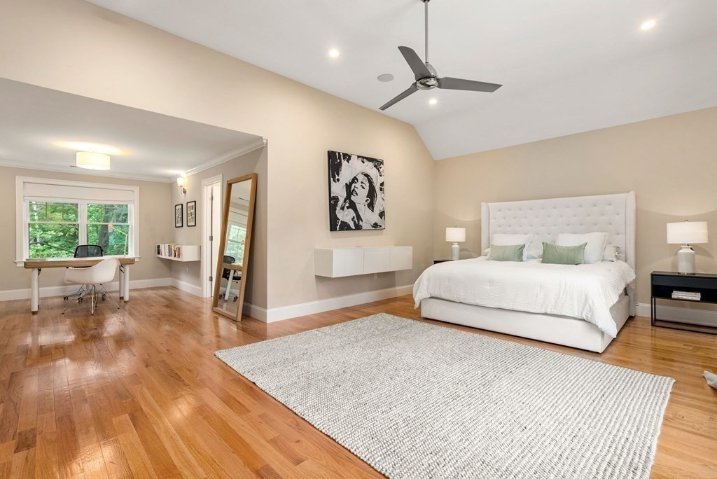 116 School Street Lexington, MA 02421 - Photo 14 of 33 a bedroom with a large bed and a chandelier