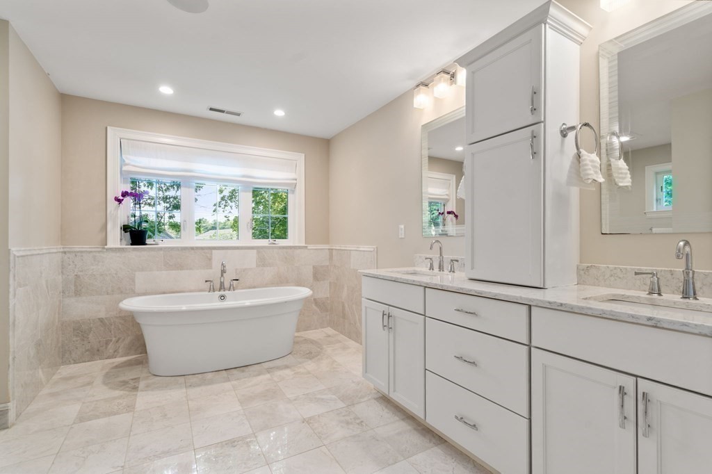 116 School Street Lexington, MA 02421 - Photo 18 of 33 a spacious bathroom with a bathtub sink and mirror