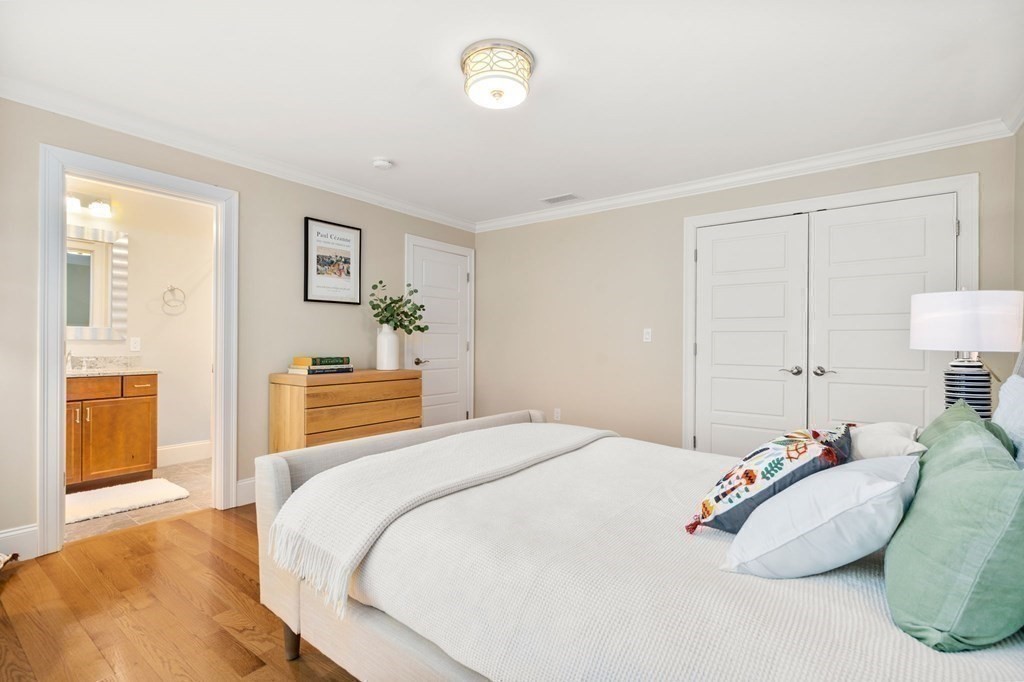 116 School Street Lexington, MA 02421 - Photo 21 of 33 a bedroom with a bed and wooden floor