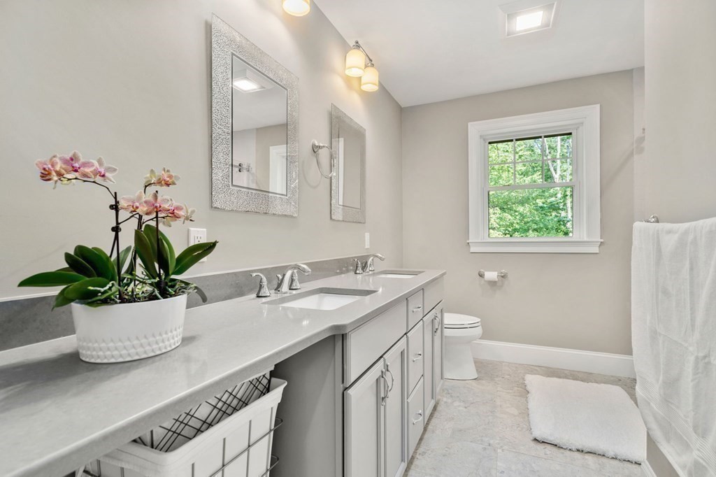 116 School Street Lexington, MA 02421 - Photo 24 of 33 a bathroom with a granite countertop sink a toilet and a mirror