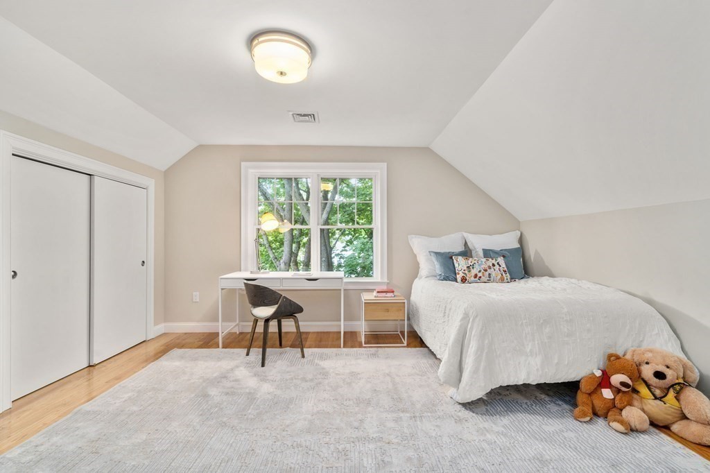 116 School Street Lexington, MA 02421 - Photo 25 of 33 a bedroom with a bed and a table in it