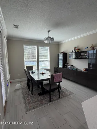 a room with furniture or chandelier and a window