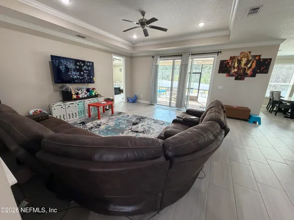 a living room with furniture and a flat screen tv