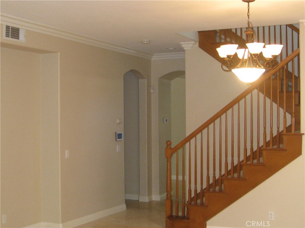 19 Coriander Irvine, CA 92603 - Photo 14 of 40 a view of a hallway with a chandelier
