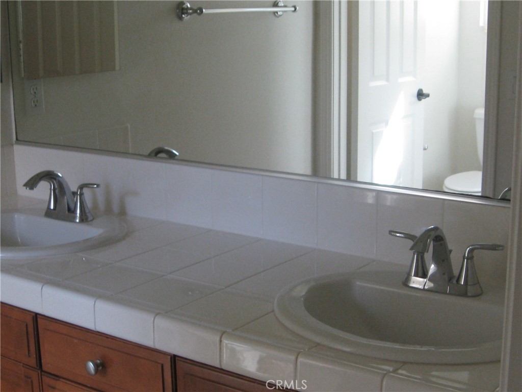19 Coriander Irvine, CA 92603 - Photo 23 of 40 a bathroom with a sink and vanity