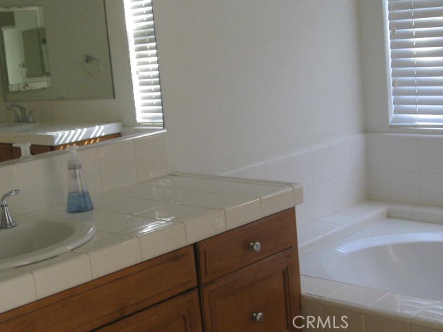 19 Coriander Irvine, CA 92603 - Photo 37 of 40 a bathroom with a sink and a mirror