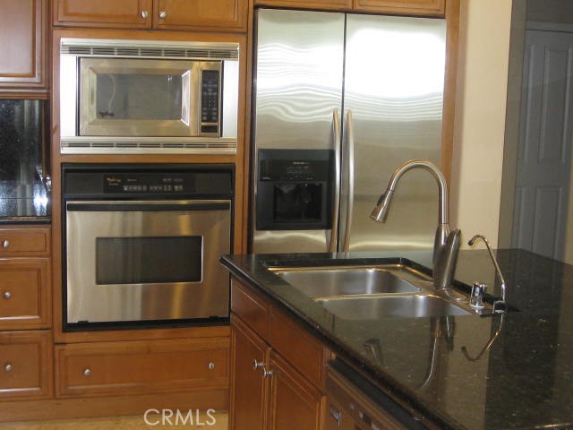 19 Coriander Irvine, CA 92603 - Photo 7 of 40 a kitchen with granite countertop a sink and stainless steel appliances