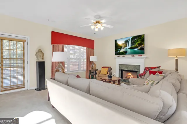 a living room with furniture a fireplace and a flat screen tv