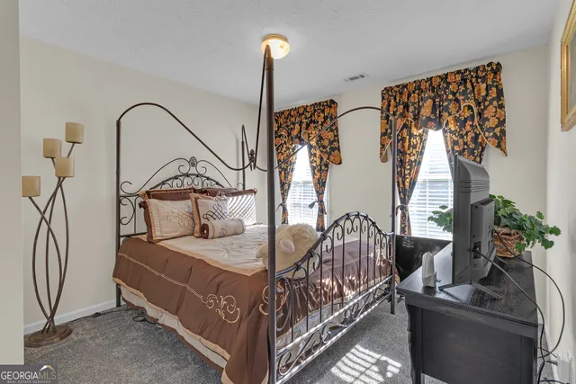 a bedroom with bed and a chandelier