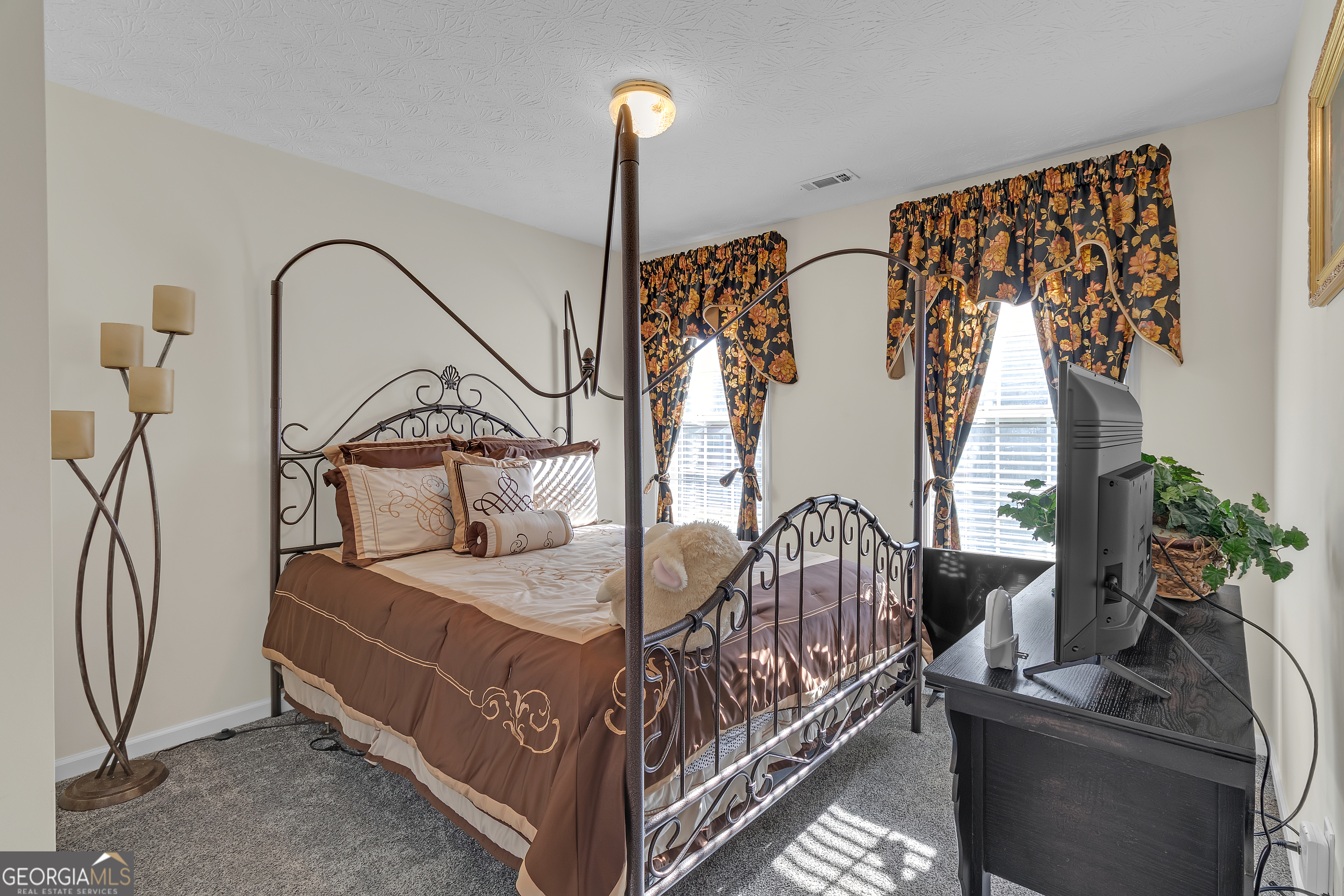 2215 Brandon Lane Southwest Conyers, GA 30094 - Photo 19 of 31 a bedroom with bed and a chandelier