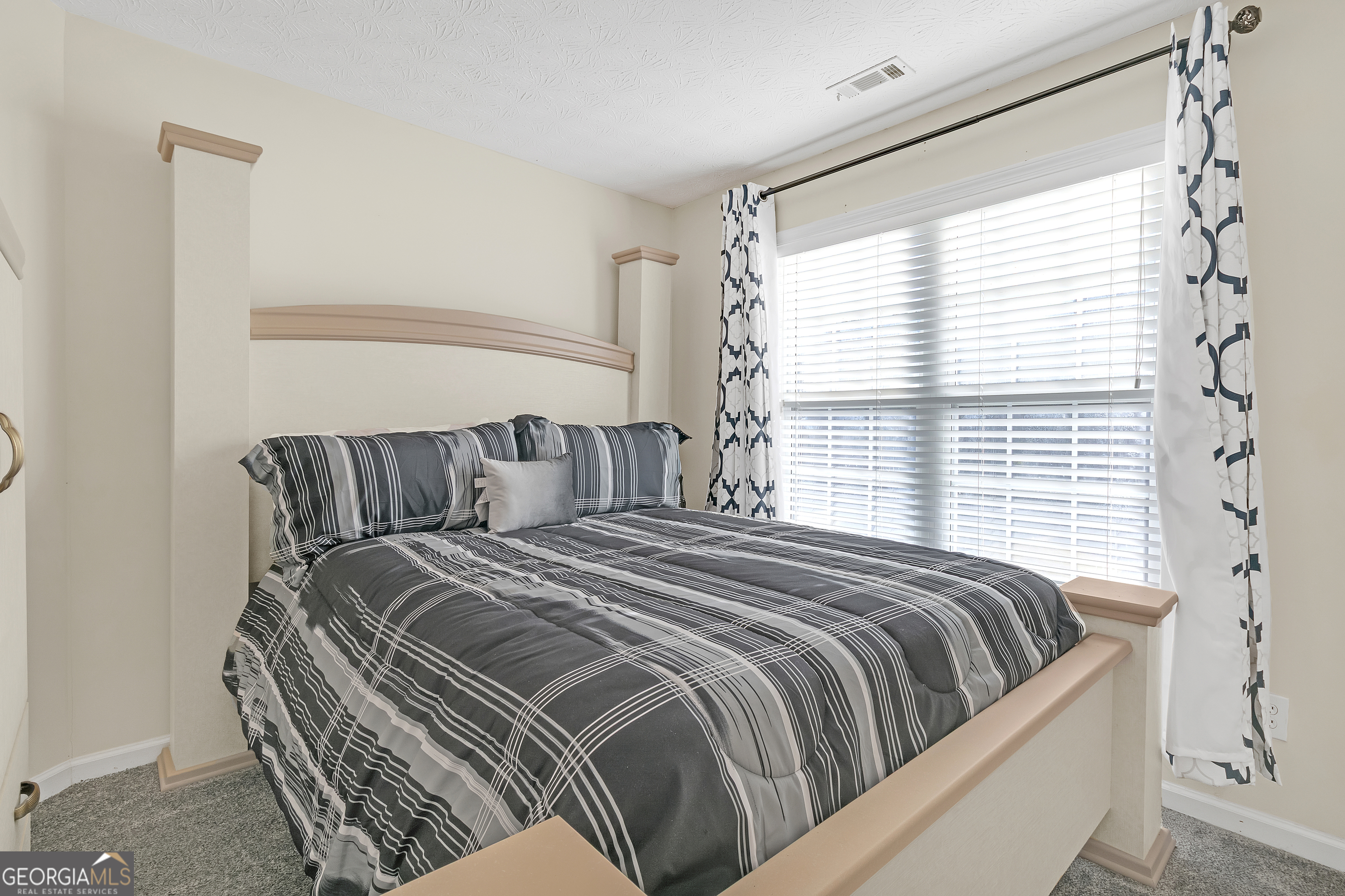 2215 Brandon Lane Southwest Conyers, GA 30094 - Photo 23 of 31 a bedroom with a bed and a window