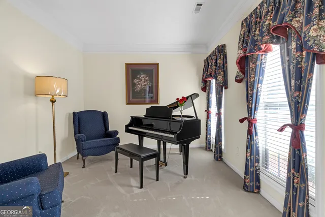 a living room with furniture and a lamp