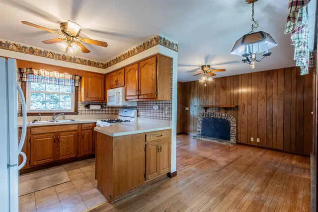 a kitchen with stainless steel appliances granite countertop a stove cabinets and wooden floor