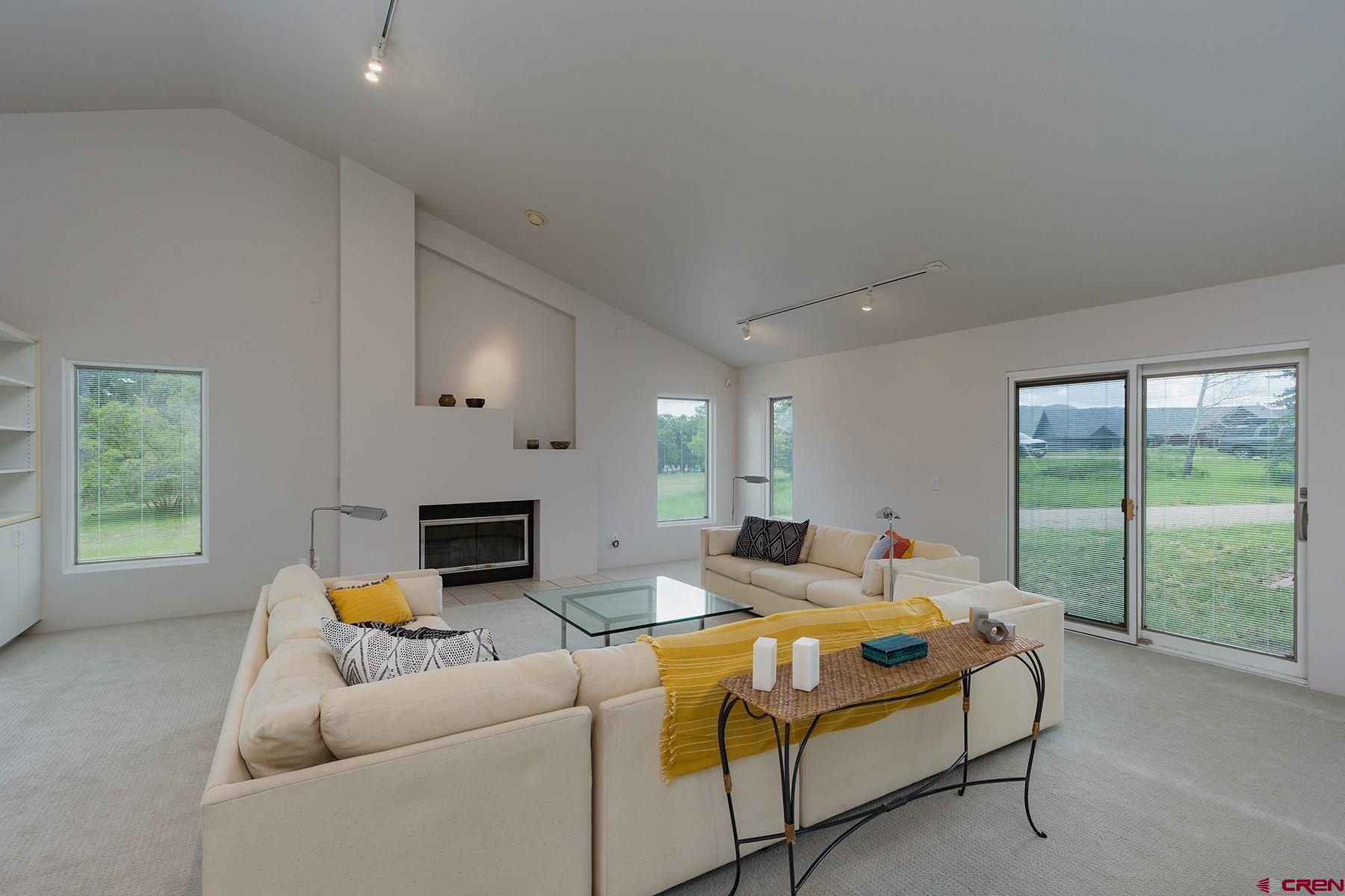 85 Blue Ridge Hesperus, CO 81326 - Photo 6 of 33 a living room with furniture a fireplace and a floor to ceiling window