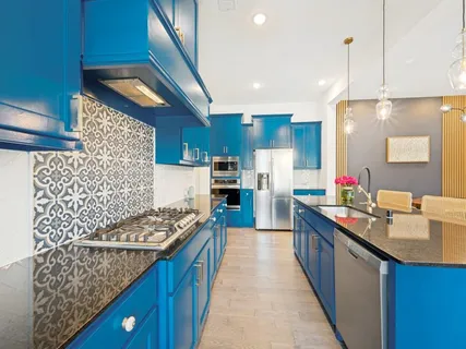a kitchen with stainless steel appliances kitchen island granite countertop a stove a sink dishwasher and a oven with cabinets
