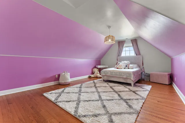 a bedroom with furniture and a rug