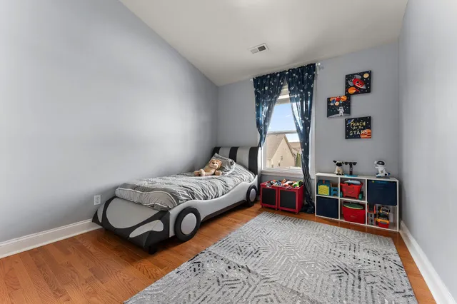 a bedroom with bed and a book shelf