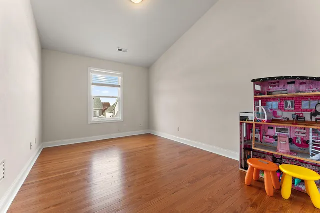 a view of a workspace with furniture and wooden floor