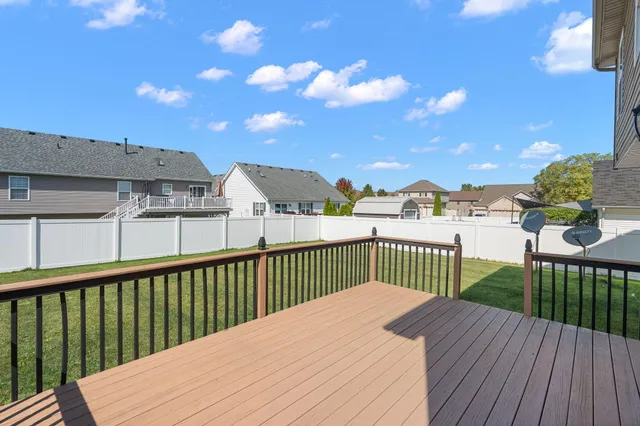 a view of a balcony with wooden floor and fence