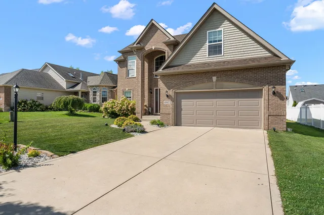 a front view of a house with a yard and garage