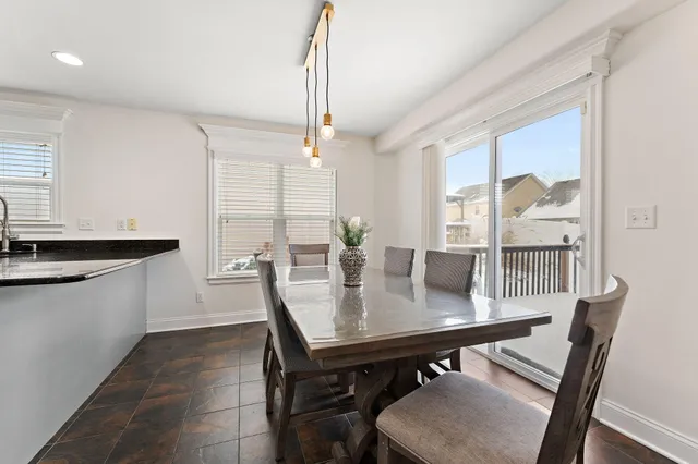 a view of a dining room with furniture and window