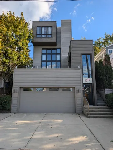 a view of a balcony with two chairs and a potted plant
