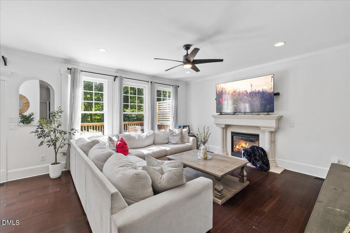 1304 Flying Hawk Road Apex, NC 27523 - Photo 16 of 52 a living room with furniture fireplace and flat screen tv
