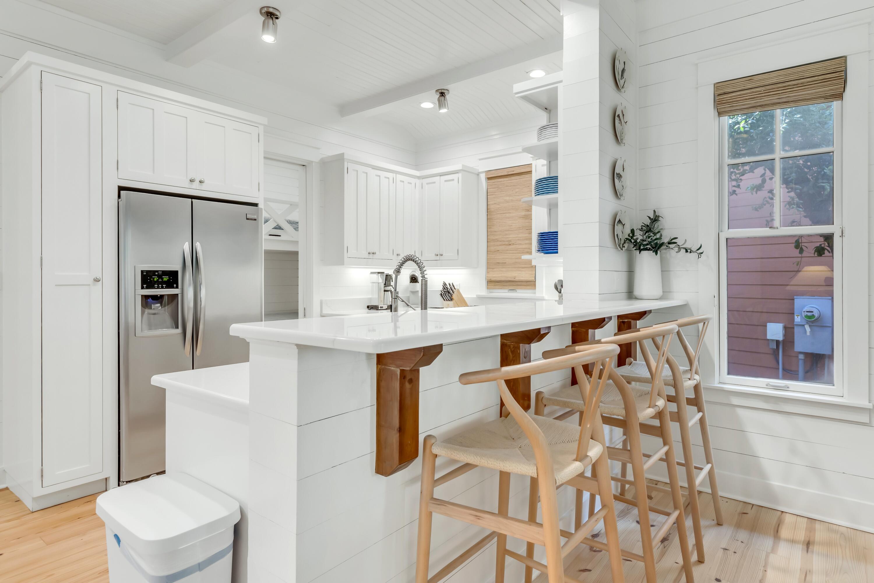 114 Sunset Ridge Lane Santa Rosa Beach, FL 32459 - Photo 14 of 90 a kitchen with white cabinets and stainless steel appliances