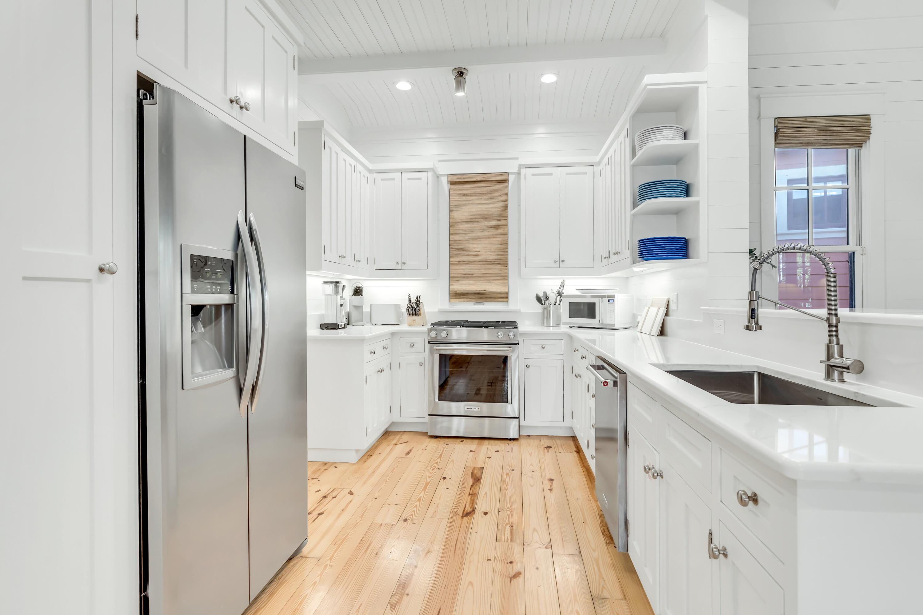 114 Sunset Ridge Lane Santa Rosa Beach, FL 32459 - Photo 3 of 90 a kitchen with white cabinets and stainless steel appliances